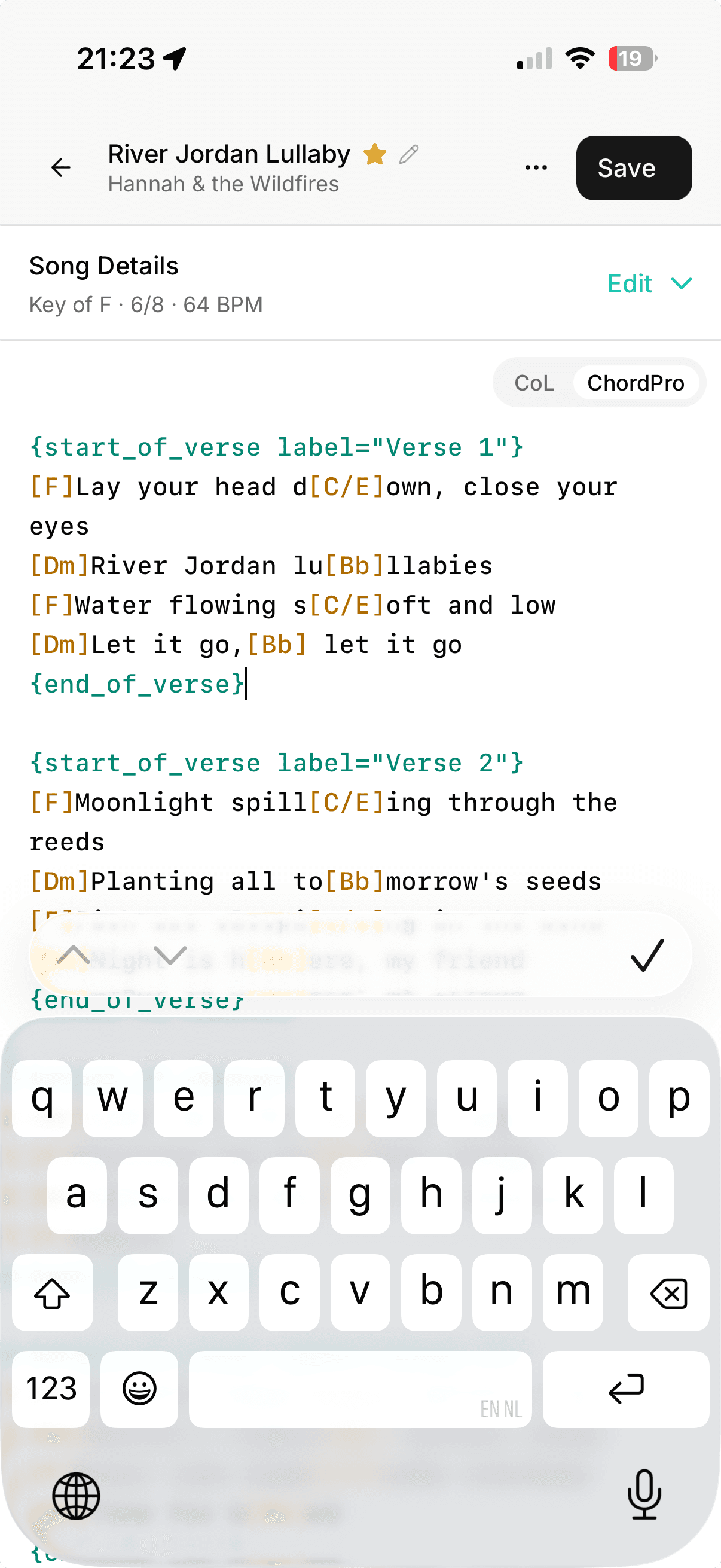 The song editor on a phone: the top bar with the song title and Save, the Song Details bar under it, the CoL and ChordPro switcher in the corner of the field, a ChordPro verse being edited, and the keyboard over the lower half